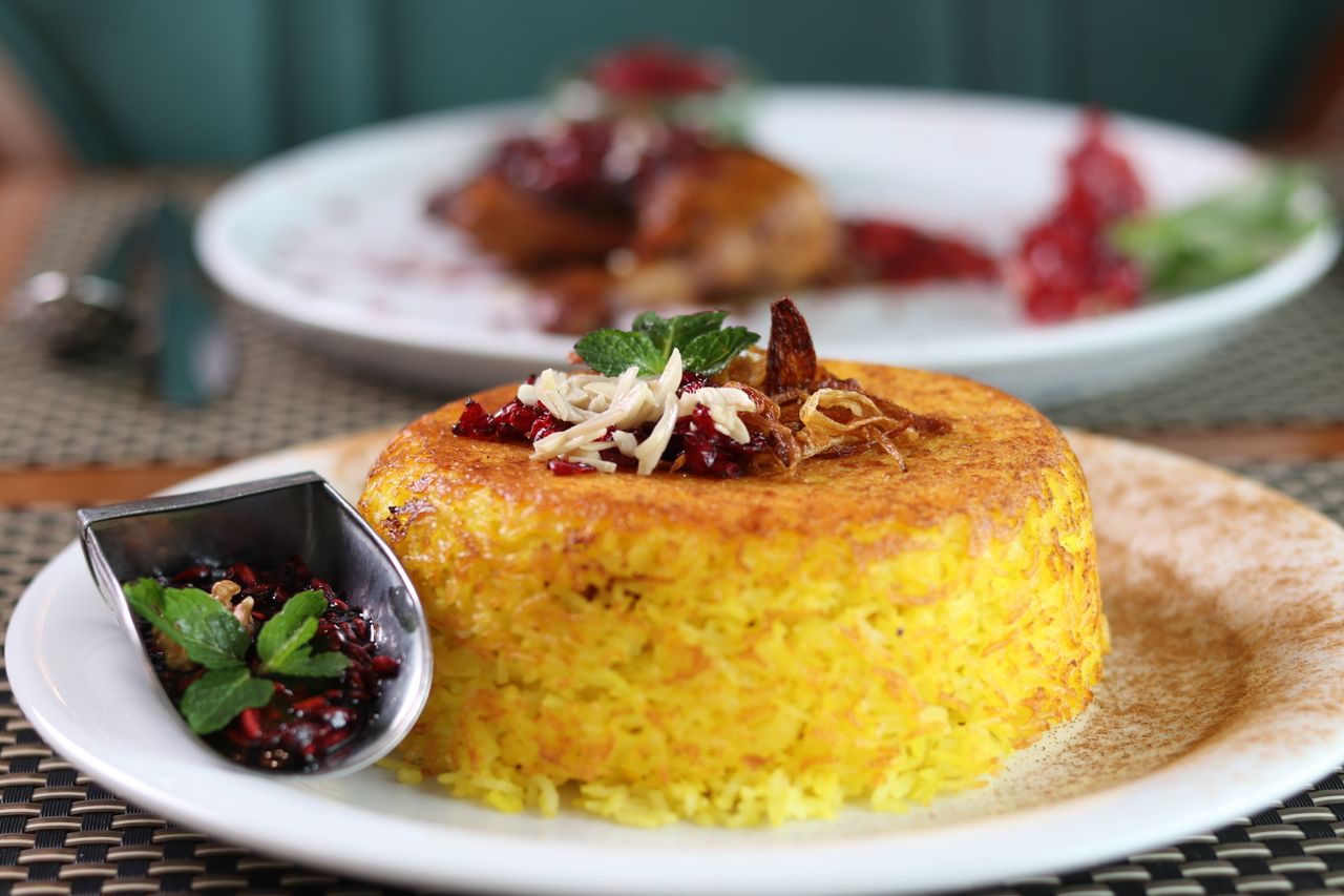about-us-01 Savor the taste of Persian cuisine with this beautifully plated saffron rice dish, perfect for dinner.